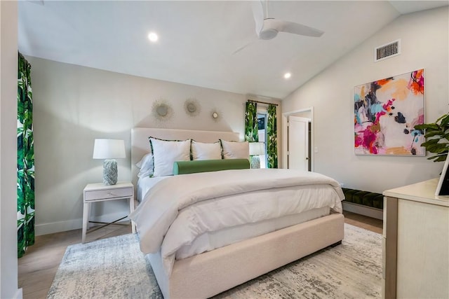 bedroom featuring light wood-type flooring, vaulted ceiling, and ceiling fan