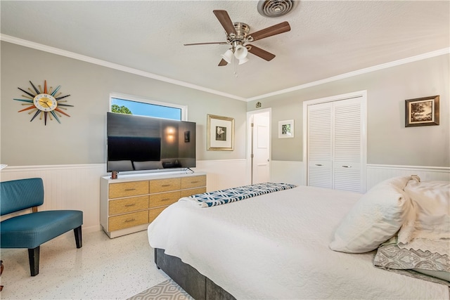 bedroom featuring ceiling fan, a textured ceiling, a closet, and crown molding