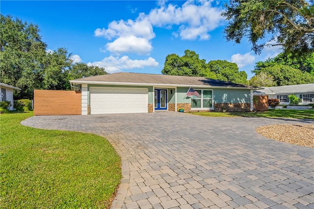 ranch-style home with a garage and a front yard