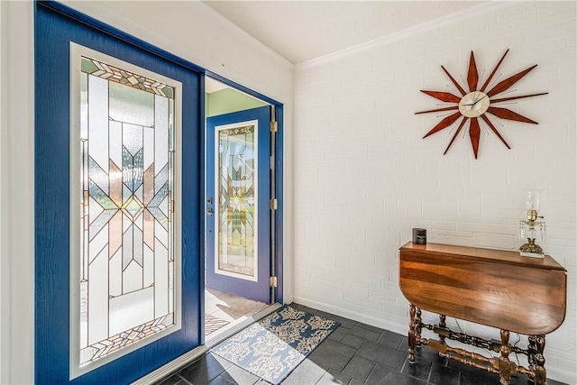 entrance foyer with brick wall and ornamental molding