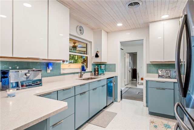 kitchen with wine cooler, sink, stainless steel fridge, and white cabinets