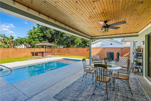 view of pool with a patio and ceiling fan