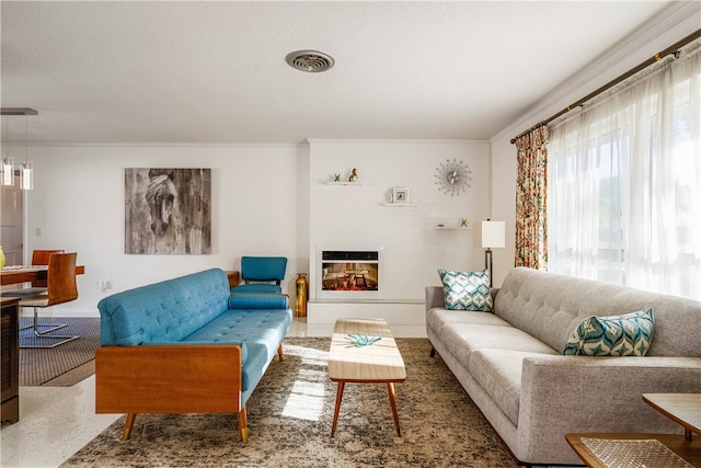 living room with a textured ceiling and ornamental molding