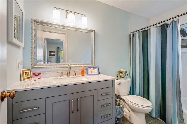 bathroom with toilet, vanity, tile patterned floors, and walk in shower