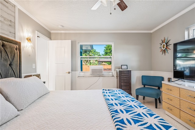 bedroom with a textured ceiling, ceiling fan, and crown molding