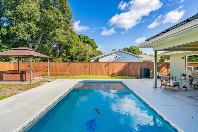 view of swimming pool featuring central AC unit, cooling unit, a hot tub, a patio, and a gazebo