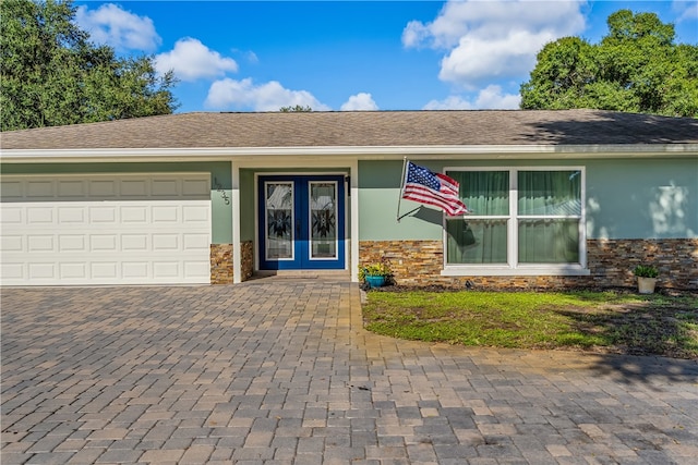 ranch-style home featuring a garage