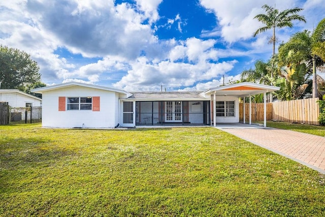 ranch-style house featuring a carport and a front lawn