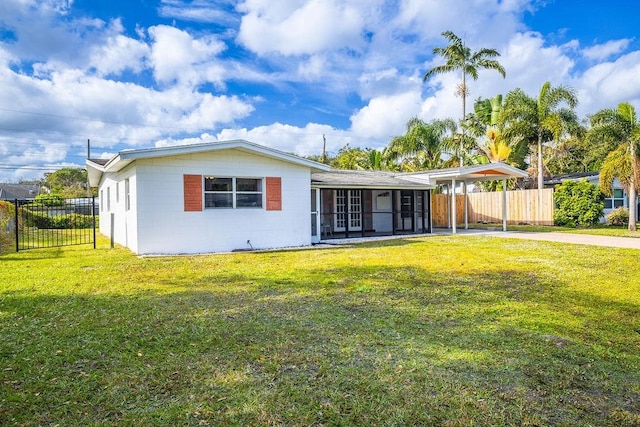 view of front of property featuring a front lawn and a sunroom