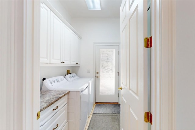 clothes washing area featuring light carpet, cabinets, and independent washer and dryer