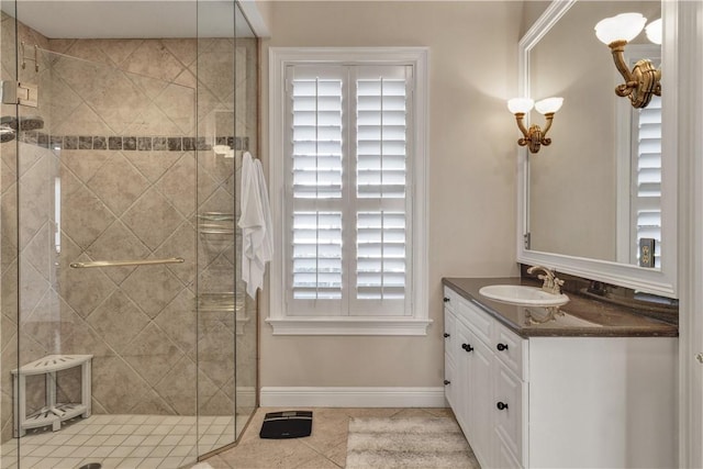 bathroom featuring tile patterned flooring, vanity, and a shower with door