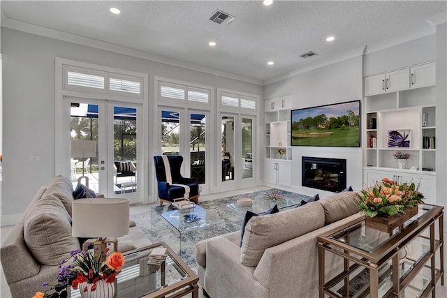 living room with crown molding, a textured ceiling, and french doors