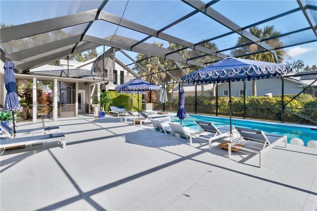 view of swimming pool featuring a lanai and a patio area