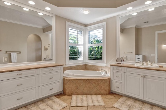 bathroom with vanity, a relaxing tiled tub, tile patterned floors, and crown molding