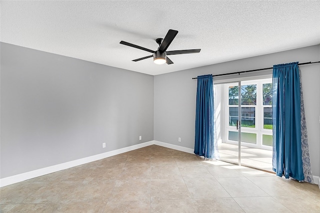 tiled empty room featuring a textured ceiling and ceiling fan