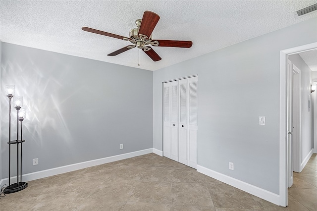 unfurnished bedroom featuring a closet, a textured ceiling, and ceiling fan