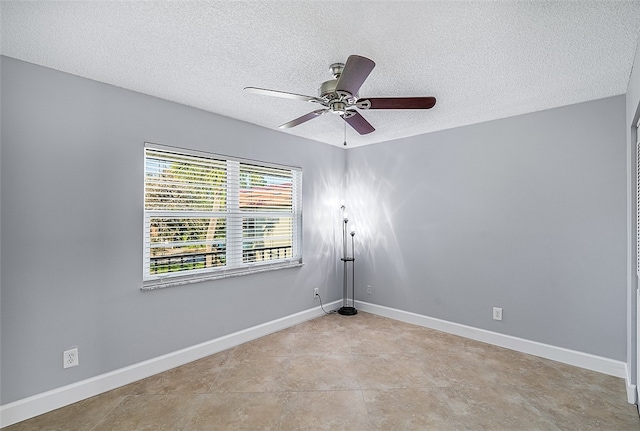 tiled spare room featuring ceiling fan and a textured ceiling