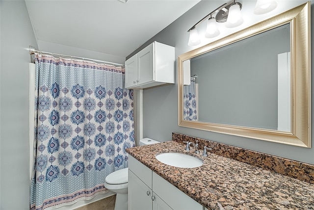 bathroom featuring vanity, toilet, and a shower with curtain