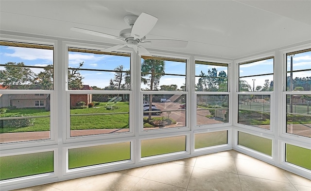 unfurnished sunroom with ceiling fan