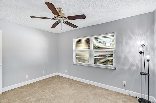 empty room featuring ceiling fan and a textured ceiling