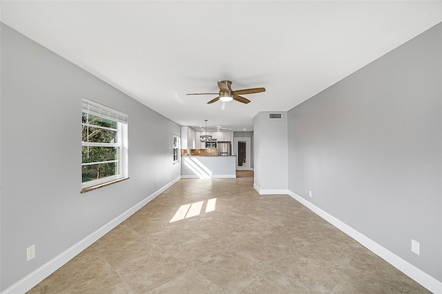 unfurnished living room featuring ceiling fan