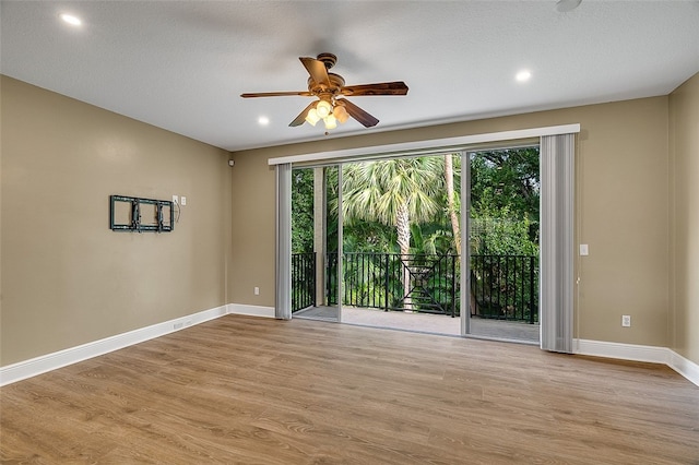 spare room featuring ceiling fan and light wood-type flooring