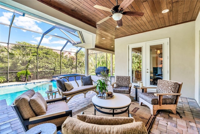 view of patio with ceiling fan, outdoor lounge area, and a lanai