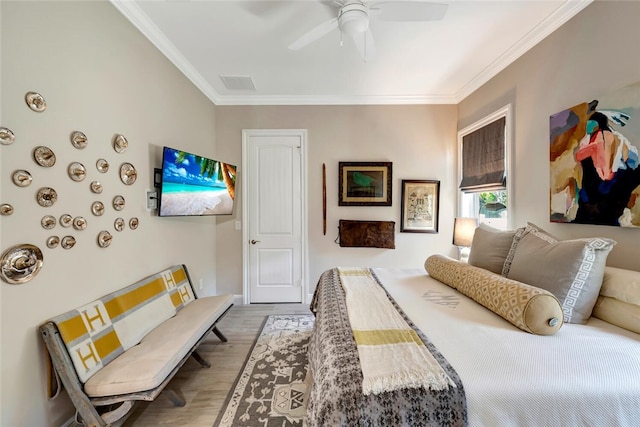 bedroom featuring crown molding, ceiling fan, and hardwood / wood-style floors