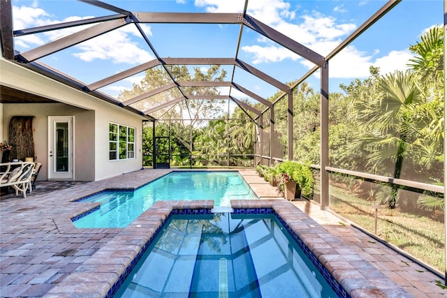 view of swimming pool with a patio and glass enclosure