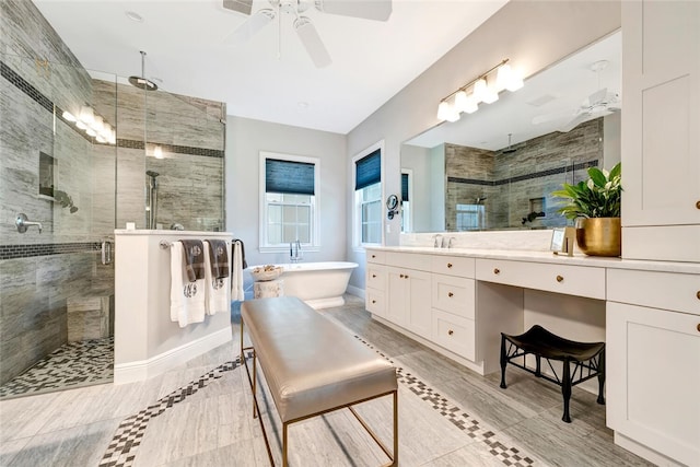 bathroom with ceiling fan, vanity, and independent shower and bath