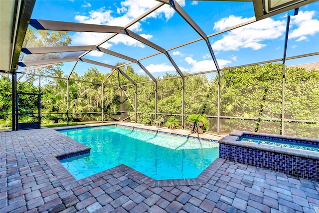 view of swimming pool featuring a lanai, a patio, and an in ground hot tub