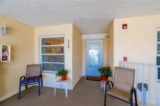 entrance to property featuring stucco siding