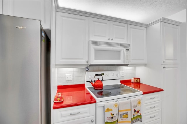 kitchen featuring a textured ceiling, white cabinetry, backsplash, and white appliances