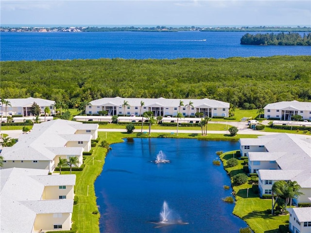 birds eye view of property featuring a residential view, a forest view, and a water view