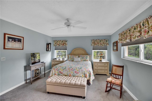 bedroom with crown molding, baseboards, carpet floors, a textured ceiling, and a ceiling fan