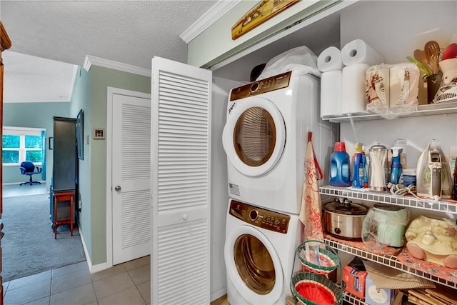 740 Lake Orchid Cir Unit 205, Vero Beach, FL 32962 - laundry room featuring stacked washer / drying machine, tile patterned floors, crown molding, carpet, and a textured ceiling