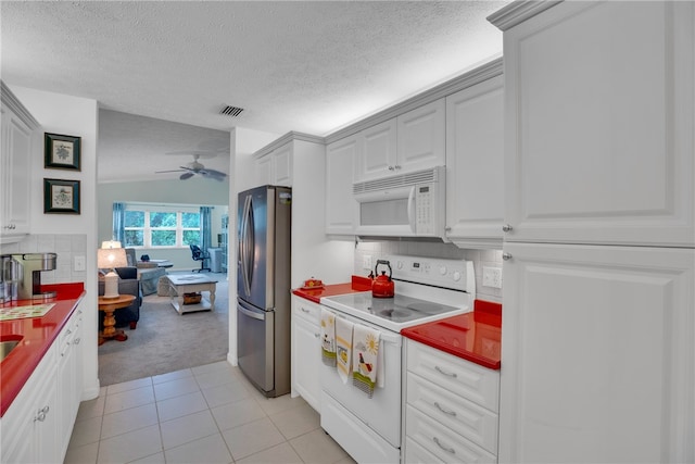 kitchen featuring white appliances, a textured ceiling, light carpet, tasteful backsplash, and ceiling fan