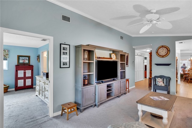 living room with light carpet, visible vents, and ornamental molding