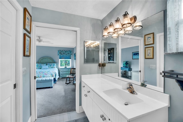 bathroom featuring ceiling fan, a textured ceiling, and vanity