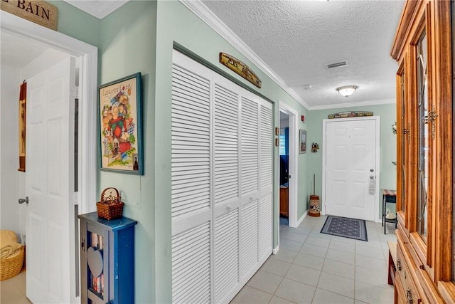 740 Lake Orchid Cir Unit 205, Vero Beach, FL 32962 - hallway featuring light tile patterned flooring, crown molding, a textured ceiling, and baseboards