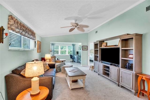 carpeted living room featuring ceiling fan, vaulted ceiling, crown molding, and a textured ceiling