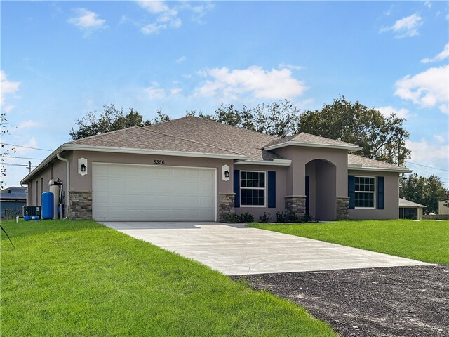 view of front facade with a front yard and a garage