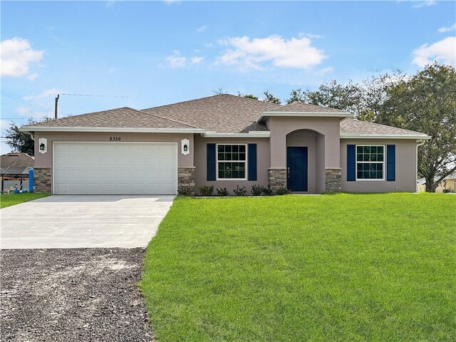 view of front of property with a garage and a front lawn