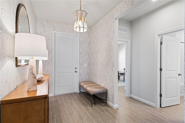 hallway with a chandelier