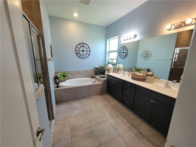 1808 Berkshire Cir SW, Vero Beach, FL 32968 - full bath with a garden tub, a shower stall, double vanity, and tile patterned floors