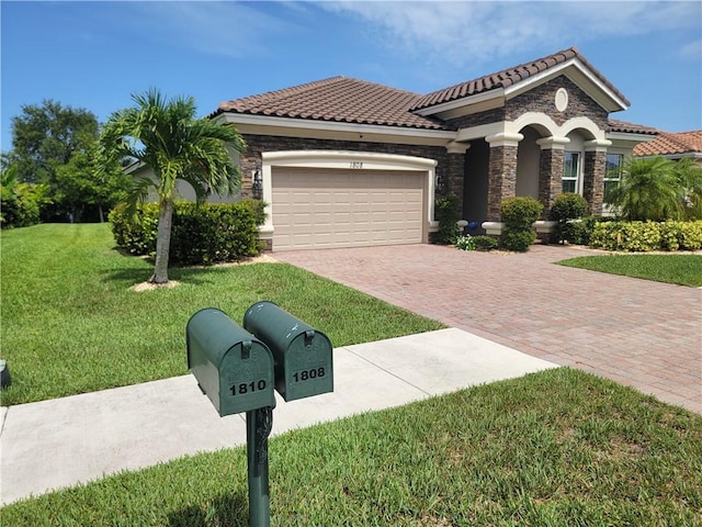 1808 Berkshire Cir SW, Vero Beach, FL 32968 - mediterranean / spanish-style house with stone siding, an attached garage, decorative driveway, and a front lawn
