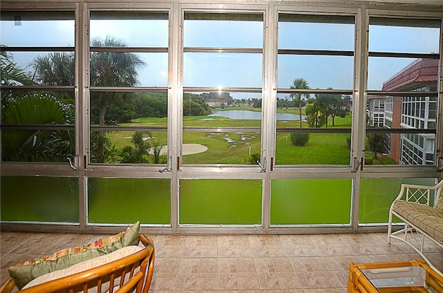 sunroom / solarium featuring a water view