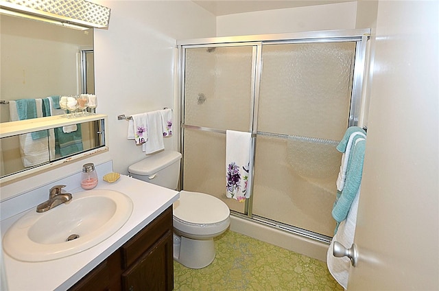 bathroom featuring walk in shower, vanity, and toilet