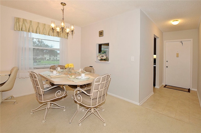 dining area featuring a textured ceiling, a chandelier, and light tile patterned floors