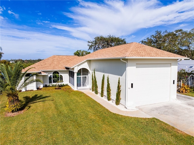 ranch-style home featuring a garage and a front yard